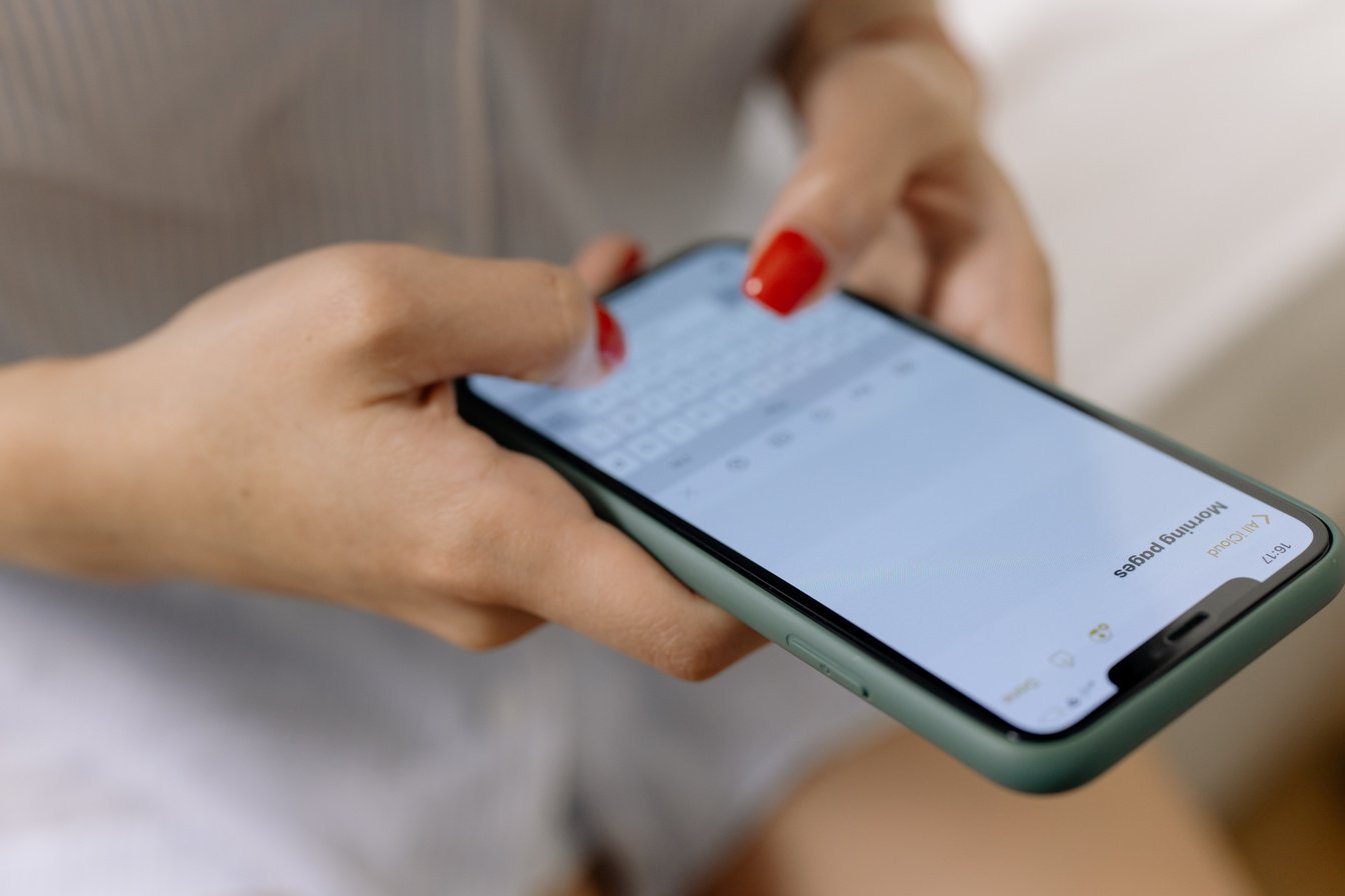 Woman Typing a Note in Mobile Phone